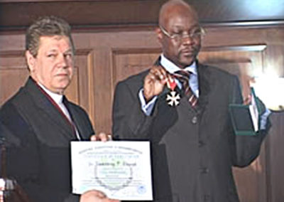 Humphrey Oborah garlanded with Cavalier of Hope Award, as Prof. Hans Kempe looks on
